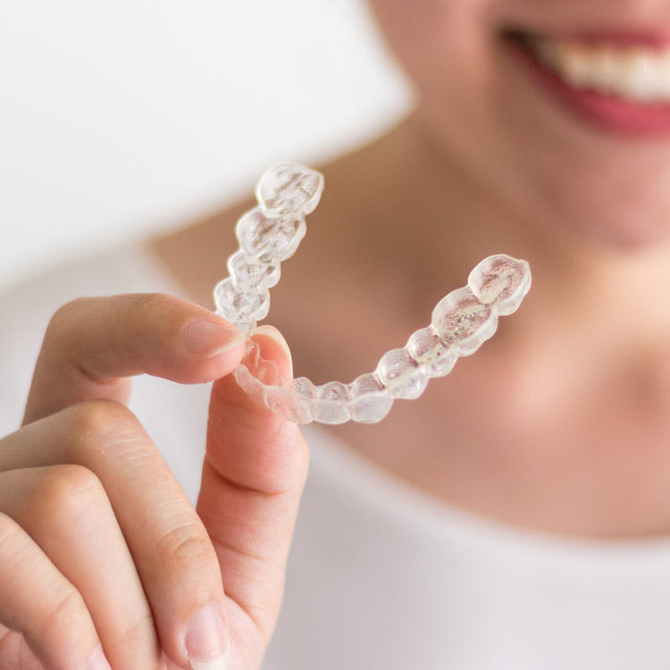 holding invisalign in hand